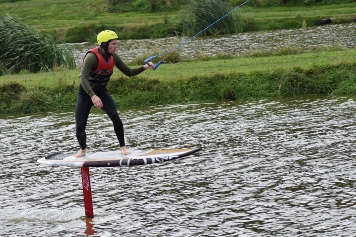 a person standing next to a body of water