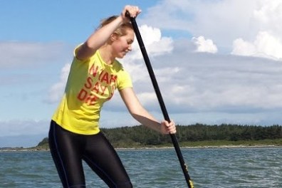 a person standing next to a body of water